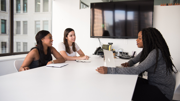 group of women sitting around a conference table