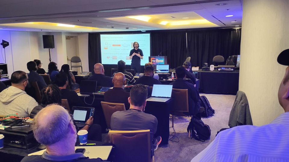 a dante certification instructor teaches a group of namm show attendees