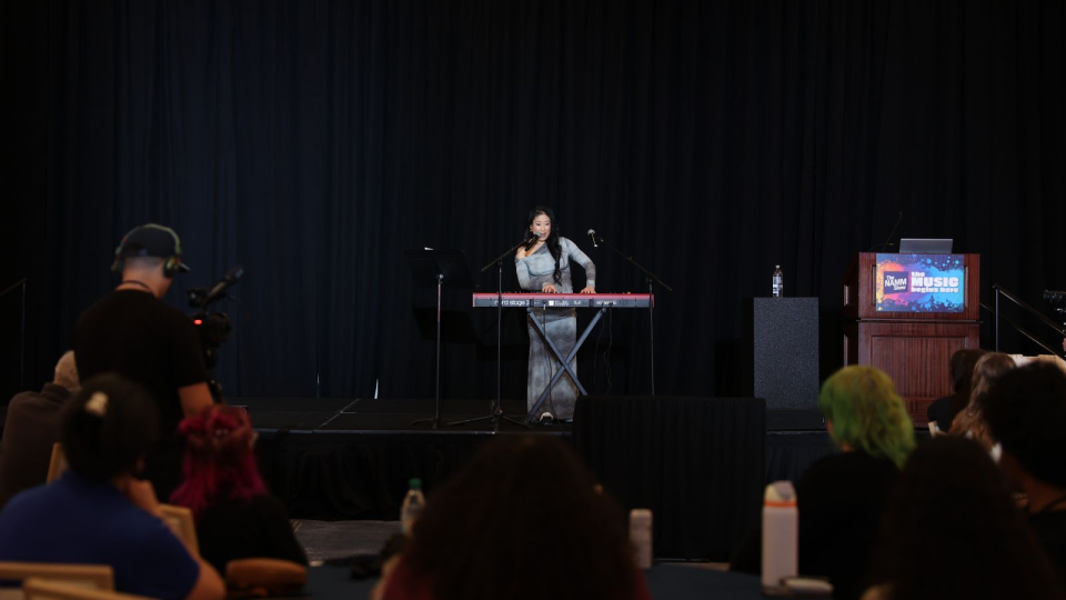 women of namm summit presenter performs on keyboard