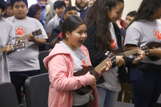a student learn the ukulele