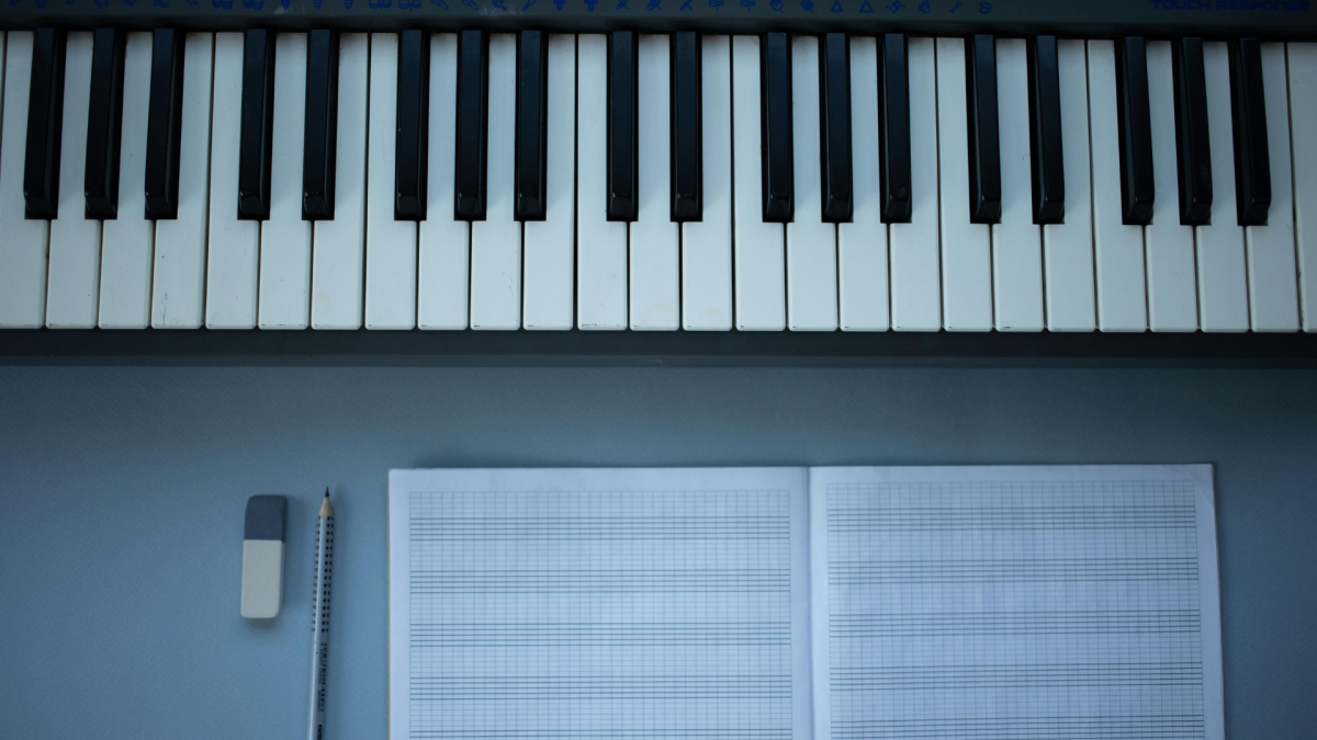 Electric piano and writing paper